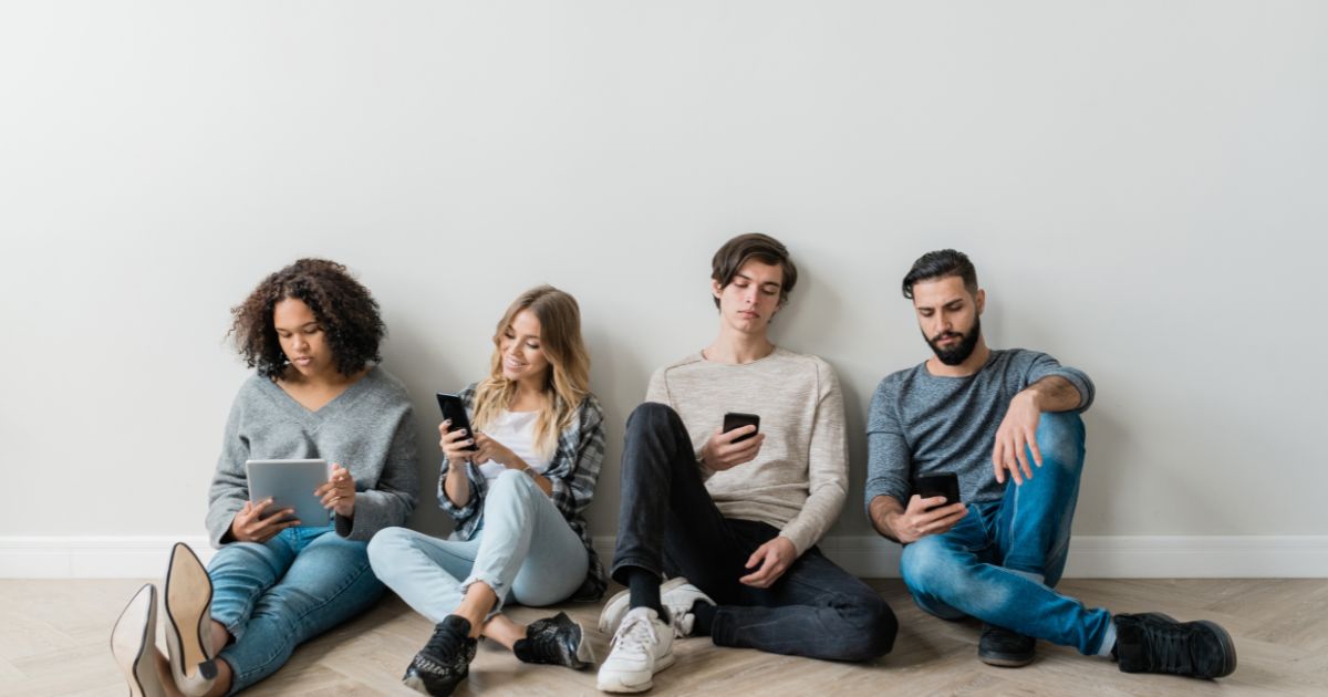 content-engaging millennials sitting on floor.